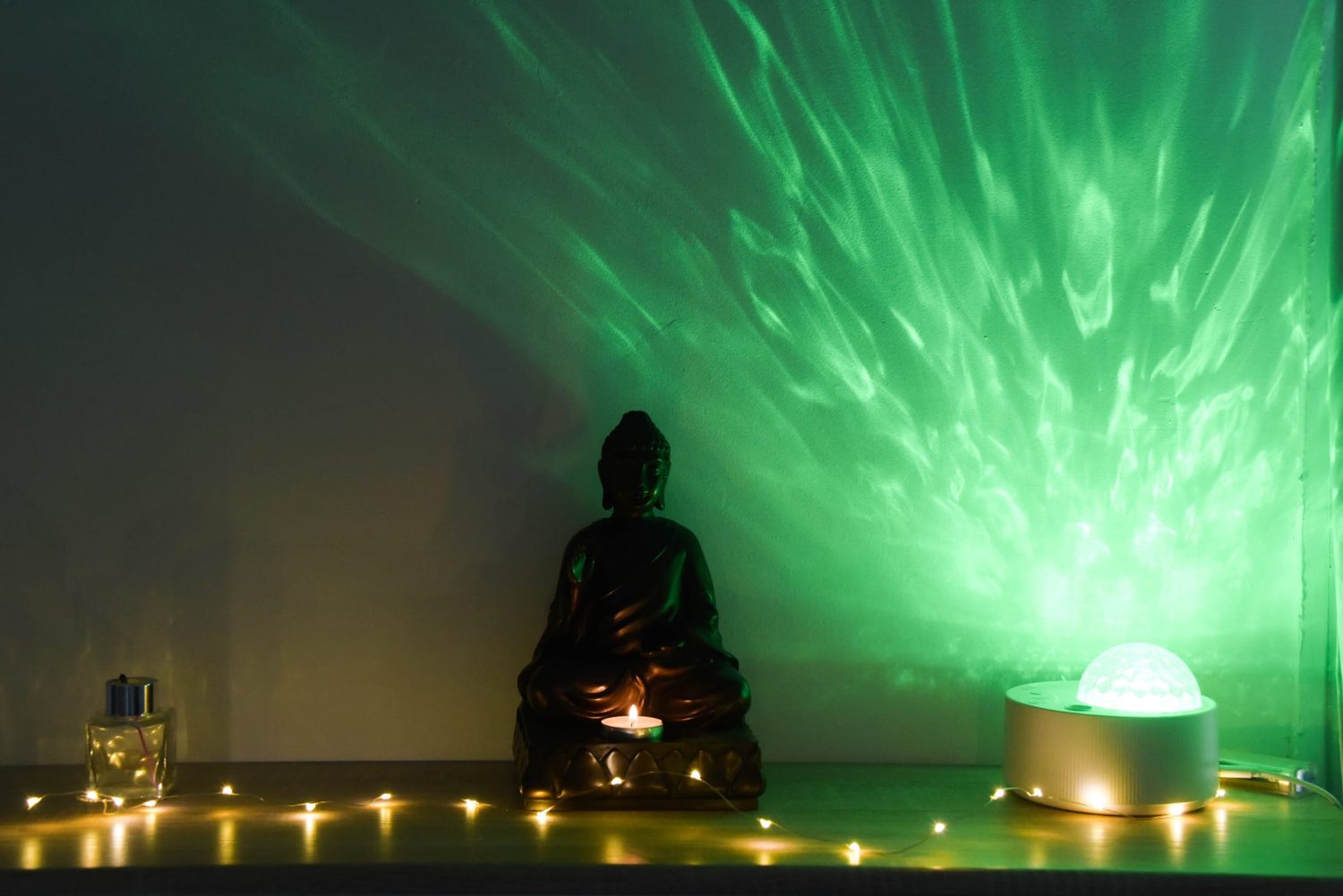 L'aurore verte projetée sur le mur de la salle de relaxation, derrière le bouddha de l'institut